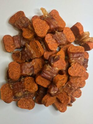 Pile of Carolina Prime Pet Peanut Butter Coated Sweet Potato Bones dog treats.